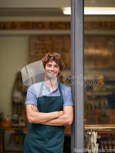 Image of Owner, arms crossed or portrait of man at restaurant for small business, coffee shop or waiter. Entrepreneur, happy smile and male barista at front door of cafe for diner and food industry confidence