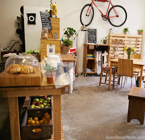 Image of Interior, space and empty coffee shop with table, chairs and furniture or small business, bistro or cafe with unique design and style. Background, restaurant startup or food counter with bike on wall