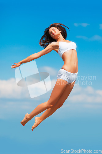 Image of Sky background, jumping and woman body in underwear with fitness energy, freedom and health goals. Mock up, clouds and sports model with jump, sunshine and healthy mindset for performance in air.