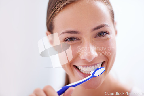 Image of Young woman, portrait and brushing teeth in bathroom with smile, health or self care for hygiene, grooming and routine. Girl, toothbrush and happiness for cleaning, healthy mouth and start morning