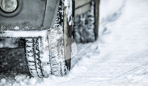 Image of Tire, winter and car in danger on snow or ice for a road trip, travel and outdoor journey using transport in cold weather. Closeup of ice, transportation and vehicle driving on a track in nature