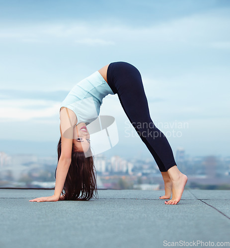 Image of Yoga, stretching and portrait of woman on roof in city, downward dog pose for wellness and balance with mockup. Health care, fitness and exercise, body workout for girl and view of cityscape rooftop.