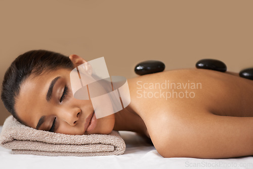 Image of Woman, rock or back massage in spa to relax for zen, sleeping or wellness physical therapy in resort. Relaxed girl client in beauty salon to exfoliate for luxury skincare healing treatment or detox