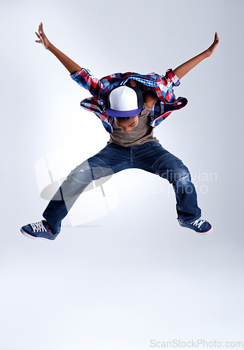 Image of Talent, jump and child hip hop dancer dancing isolated in a white studio background in a pose feeling excited. Dance, jumping and boy kid with energy and skill ready for breakdance performance