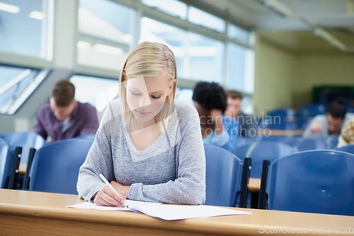 Image of Writing, woman and student with knowledge, education and learning with text, concentration and development. Female person, academic or group in a classroom, examination and innovation with a document