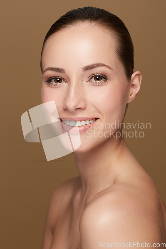 Image of Portrait, beauty and woman with a smile, dermatology and skincare against brown studio background. Face, female person or model with wellness, bare and cosmetics with confidence, luxury and soft skin