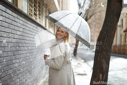 Image of Umbrella, city street portrait and woman in rain with happiness on a sidewalk from winter weather. Happy female person, raining and travel on a urban road outdoor in New York on holiday with joy