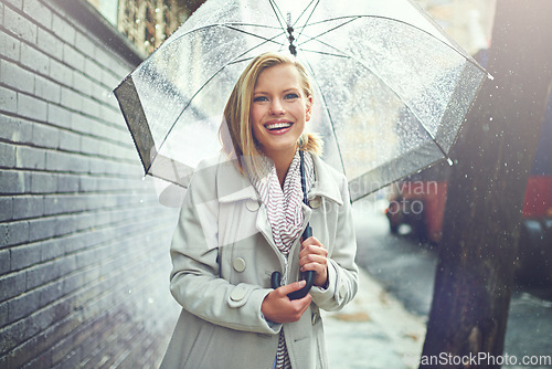 Image of Rain umbrella, city street portrait and woman with happiness on a sidewalk from winter weather. Happy female person, raining and travel on urban road outdoor in New York holiday with freedom and joy