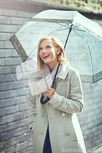 Image of Umbrella, city rain and excited woman with happiness on a sidewalk from winter weather. Happy female person, raining and travel on a urban road outdoor in Cape Town on holiday with freedom and joy