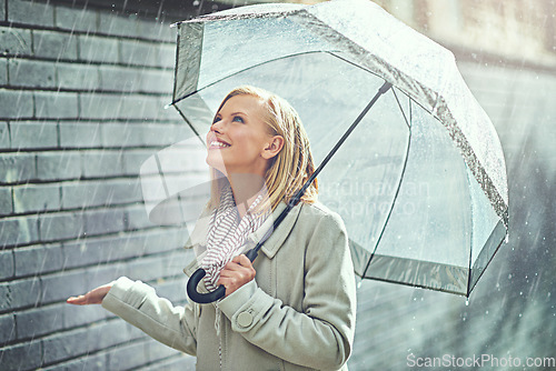 Image of Rain umbrella, city street and woman smile with happiness on a sidewalk from winter weather. Happy female person, raining and travel on a urban road in New York on holiday with freedom and joy