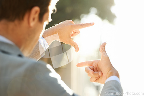 Image of Hand, frame and closeup of business man in city for vision, focus and thinking with mockup. Inspiration, planning and idea with male employee and finger gesture for freedom, motivation and insight