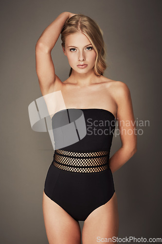 Image of Underwear, beauty and portrait of woman in a bodysuit for fashion, sexy body and self care. Aesthetic female model with a natural skin glow, lingerie or swimwear and seductive pose on grey background