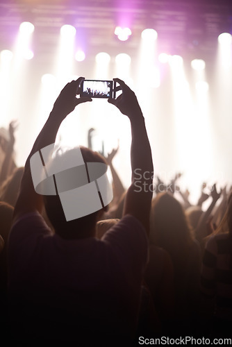 Image of Streaming, concert and hands of audience with phone for pictures, celebration and enjoying stage, music or event. Party, people and performance with excited fans showing support, passion or recording