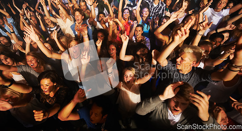 Image of Music, dance and party with crowd at concert for rock, live band performance or festival. New year, energy and disco with audience of fans listening at celebration for techno, rave or nightclub event