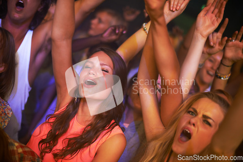 Image of Music, energy and party with woman at concert for rock, live band performance and festival show. New year, celebration and disco with girl dance in crowd of fans for techno, rave and nightclub event