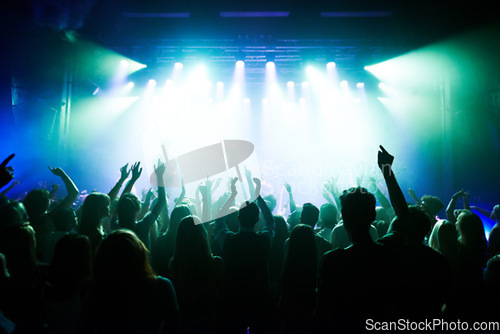 Image of Music, dance and party with crowd at concert for rock, live band performance and festival show. New year, celebration and disco with audience of fans listening to techno, rave and nightclub event