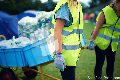 Image of Recycling, community service hands and volunteer work outdoor with cans and garbage at a park. Cleaning, sustainability and bottle recycle with people with rubbish and pollution for environment