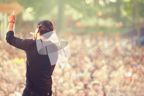 Image of Music, microphone and singer with man at concert for rock festival, performance and party in nature. Celebration, energy and audience with male musician on stage for club, show and event in outdoors