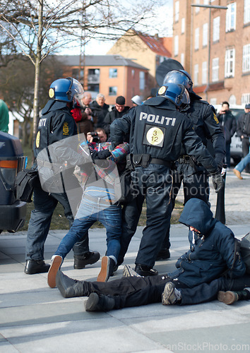 Image of Police men, criminal and arrest in the city of Denmark for street safety, security or law enforcement. Group of legal government officers arresting people in a urban town for crime, justice or riot