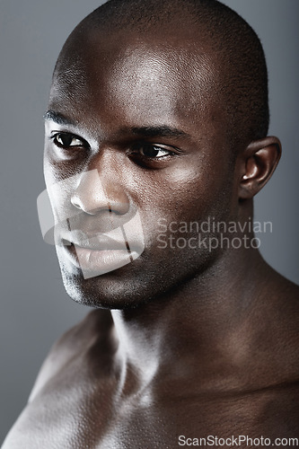 Image of Aesthetic, beauty and face black man on dark background with muscle, motivation for fit and serious person. Health, art and face of strong African male model isolated on studio backdrop with wellness