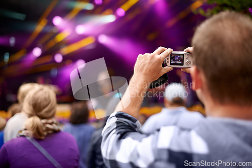 Image of Music, camera and party with man at festival for stage picture, social media and summer. Techno, photography or streaming at rave with male photographer in crowd for carnival, energy and rock event