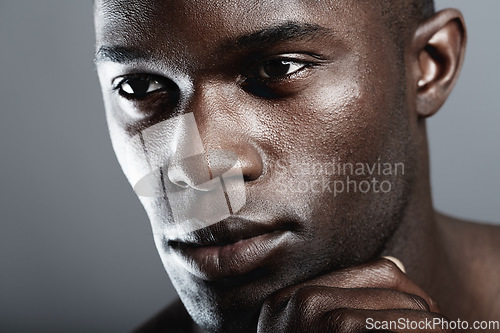 Image of Beauty, skin care and face of black man on dark background with male cosmetics, strong and serious glow closeup. Health, wellness and dermatology, African skincare model isolated on studio backdrop.