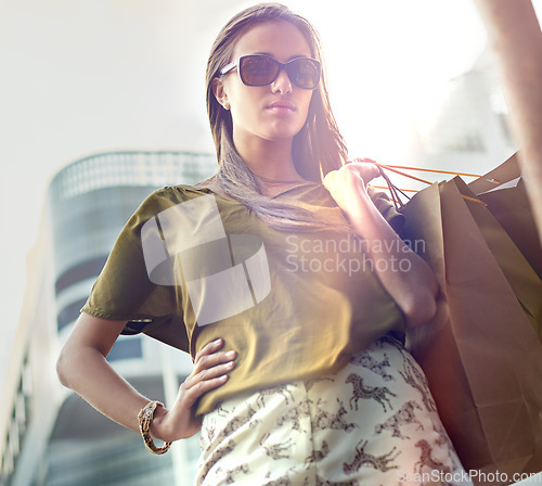 Image of Shopping bag, city portrait and confident woman with fashion clothes purchase, retail product or store discount. Pride, sales spree and chic female customer with sunglasses, luxury brand or mall gift