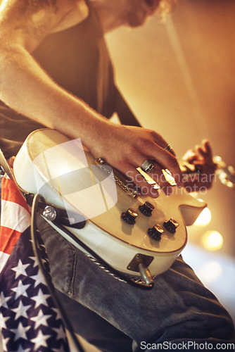 Image of Guitar, hands and stage in closeup for rock concert, performance and singing at party, event and night. Male musician, artist or rockstar with instrument at music festival for art, sound and career