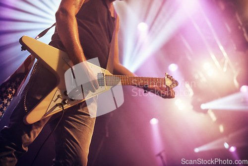 Image of Guitar, man and performance for concert, rock or singing at party, event or celebration in night. Male musician, artist or rockstar with instrument at music festival for art, sound or talent on stage