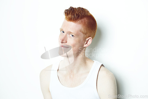 Image of Happy, ginger and portrait of man in studio for casual, red hair and trendy style. Natural, smile and shy with face of male model isolated on white background for confident, pride or mockup