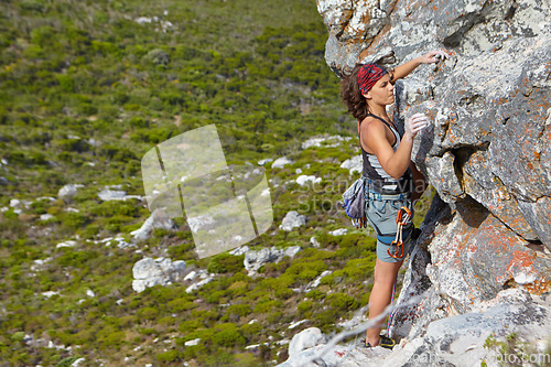 Image of Rock climbing, freedom and challenge with woman on mountain for adventure, travel and explore. Strong, fitness and cliff with female climber training in nature for courage, safety and workout