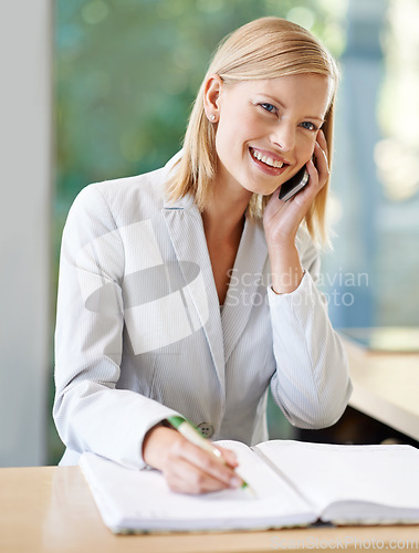 Image of Woman, phone call and receptionist taking notes, smile and talking at reception. Cellphone, notebook and female secretary writing or person in conversation, booking and communication at hotel spa.