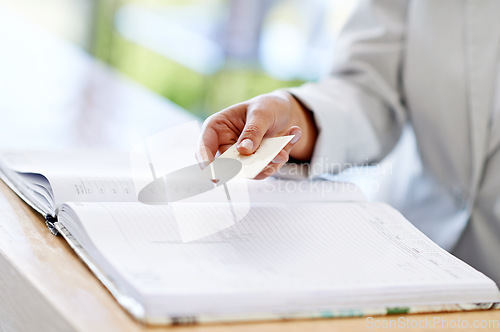 Image of Woman, hands and credit card with book for payment, transaction or purchase for appointment or reservation. Hand of female showing debit at reception to buy, pay or shopping for booking or check in