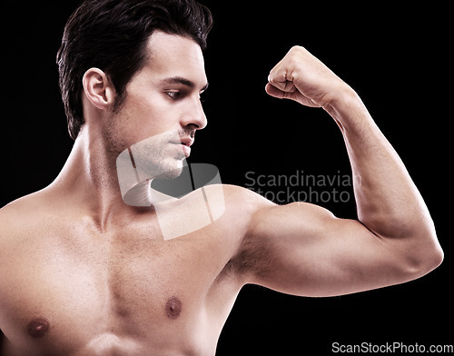 Image of Man, bodybuilder and bicep flex in studio, black background and exercise for muscular power. Strong, sexy and topless male model, sports athlete and arm muscle for pride, training and fitness results