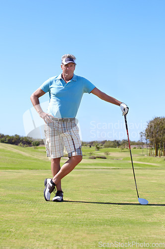 Image of Portrait, golf and old man with driver on a field for training, hobby and sports on blue sky background. Sports, face and active senior male golfer outdoor for retirement, fitness or practice game