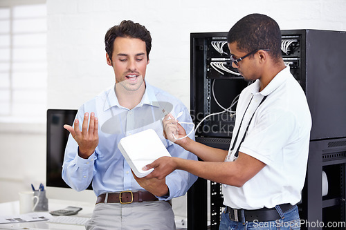 Image of Server room, it support and modem with a technician explaining to a business man about cyber security. Network router, database and consulting with an engineer chatting about information technology