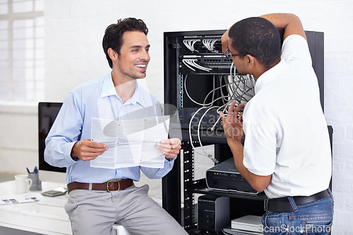 Image of Server room, it support and manual with a technician talking to a business man about instructions to follow. Network, database and installation with an engineer chatting about information technology