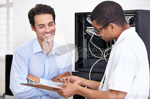 Image of Server room, happy man or technician speaking of hardware maintenance or glitch in business office. Network, tech support or worker with electrician or electrical engineer for information technology