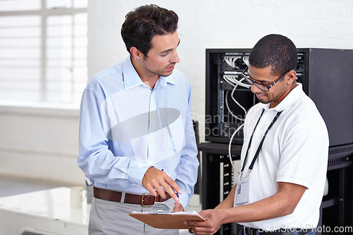 Image of Server room, clipboard and discussion with a technician talking to a business man about a cyber security contract. Network, database and documents with a male engineer chatting about an agreement