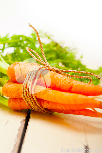 Image of baby carrots bunch tied with rope