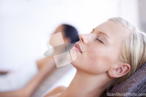 Image of Spa, relax and face of a woman on a bed for beauty, massage or skincare. Calm female client on a table with eyes closed and peace with luxury facial cosmetics, zen treatment or health and wellness