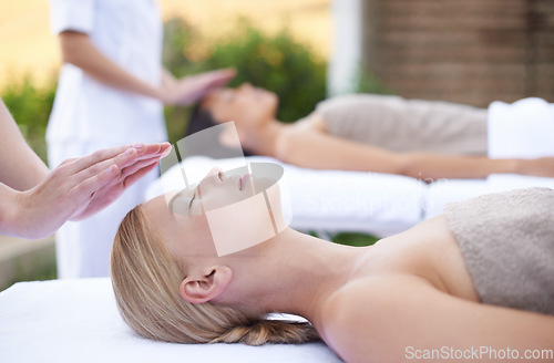 Image of Reiki, facial flow and women at spa for health, wellness and chakra energy healing with luxury stress relief treatment. Beauty salon, skin care and woman in holistic massage on face for calm aura.