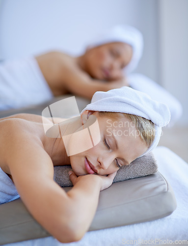 Image of Spa, lying and face of a woman for wellness, beauty or facial skincare. Female client or customer on a massage table with a towel and peace for luxury cosmetics, zen treatment or health and wellness