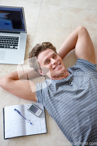 Image of Laptop, relax and top view man on floor with books for writing notes, ideas and brainstorming. Education, knowledge and male student laying with textbook and computer for online learning at home