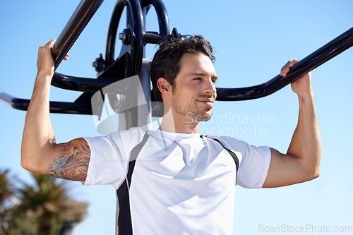 Image of Happy man, fitness and arm equipment at park gym for exercise, shoulder press or training in the nature outdoors. Fit, active or strong male exercising on workout machine for weightlifting strength