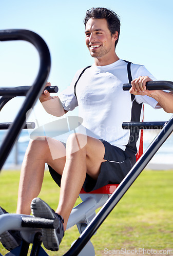 Image of Happy man, fitness and shoulder press on park equipment for gym workout, exercise or training in nature. Fit, active and strong male exercising on outdoor machine for muscle, chest or weightlifting