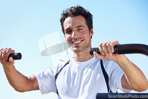 Image of Happy man, fitness and portrait in shoulder press at park for gym workout, exercise or training in nature. Fit, active or strong male exercising on outdoor machine for muscle, chest or healthy cardio