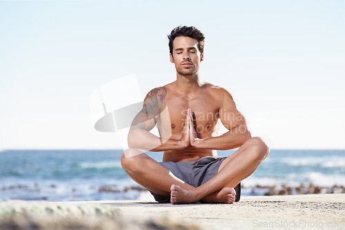 Image of Man, relax and yoga in meditation on beach for spiritual wellness, inner peace or mental wellbeing in nature. Calm male yogi in meditate pose for balance, healthy body or mindfulness by the ocean