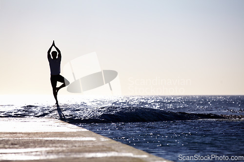 Image of Man, silhouette and yoga in meditation on ocean at beach for spiritual wellness, inner peace or mental wellbeing space. Male yogi in tree pose for balance, healthy body or mindfulness on sea mockup