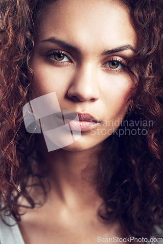 Image of Beauty, closeup and portrait of woman in studio confident, beautiful and gorgeous on gray background. Salon, facial glow and face of female person with natural makeup, cosmetics and curly hairstyle